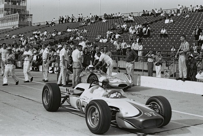 Masten Gregory tells Mickey Thompson that the car continues to lift. Parnelli Jones heads out for a run
